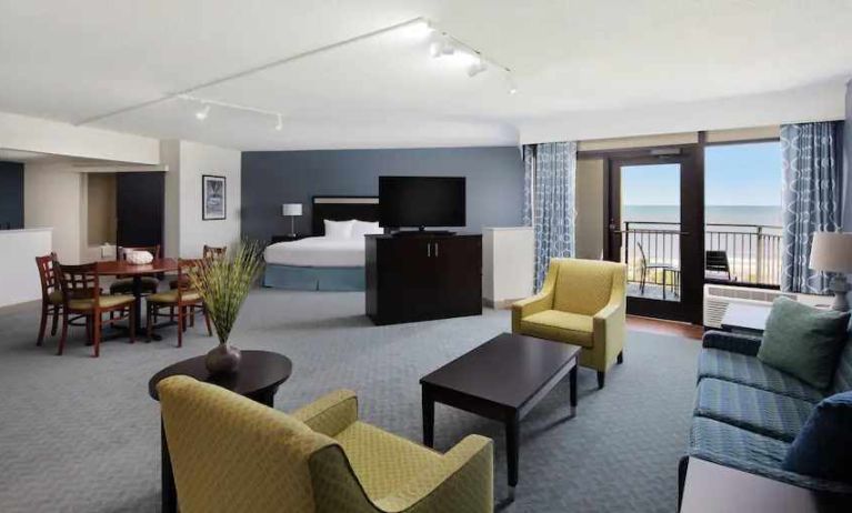 Spacious king suite with king size bed, working station and balcony at the DoubleTree by Hilton Myrtle Beach.