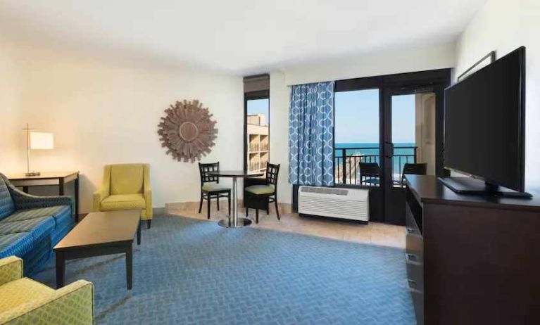 Living area with working station in a king suite at the DoubleTree by Hilton Myrtle Beach.