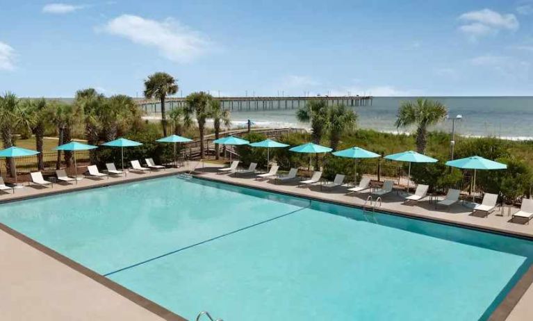 Beautiful outdoor pool area with lounges at the DoubleTree by Hilton Myrtle Beach.