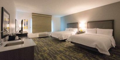 Double queen bedroom at the Hampton Inn & Suites by Hilton-Irvine/Orange County Airport.