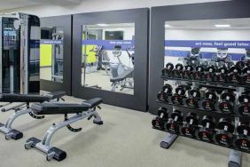 Fitness center with weights at the Hampton Inn & Suites by Hilton-Irvine/Orange County Airport.