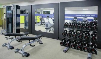 Fitness center with weights at the Hampton Inn & Suites by Hilton-Irvine/Orange County Airport.