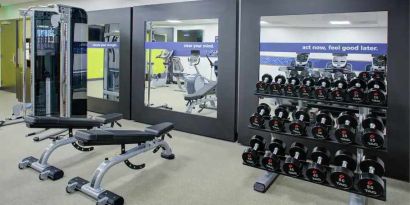 Fitness center with weights at the Hampton Inn & Suites by Hilton-Irvine/Orange County Airport.