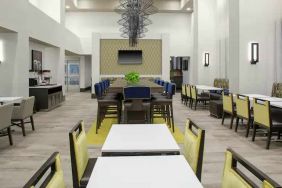 Comfortable dining area perfect as workspace at the Hampton Inn & Suites by Hilton-Irvine/Orange County Airport.