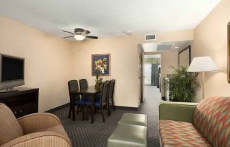 Living area with working station in a king suite at the Embassy Suites by Hilton Miami - International Airport.