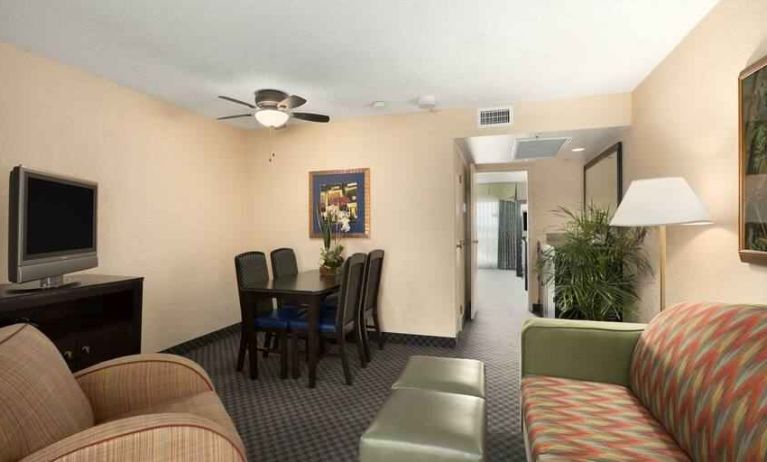 Living area with working station in a king suite at the Embassy Suites by Hilton Miami - International Airport.