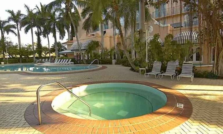 Outdoor patio with pools perfect as workspace at the Embassy Suites by Hilton Miami - International Airport.