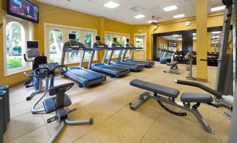 Fitness center with treadmills and machines at the Embassy Suites by Hilton Miami - International Airport.