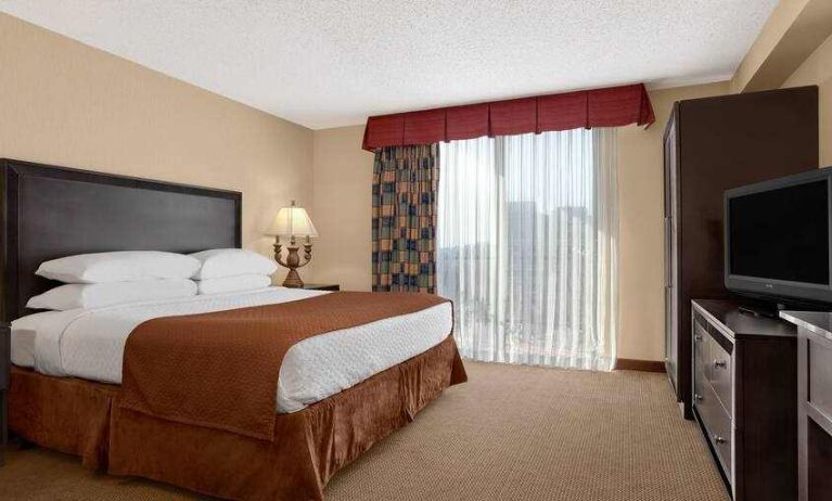 Hotel guestroom with king size bed and window at the Embassy Suites by Hilton Kansas City Plaza.