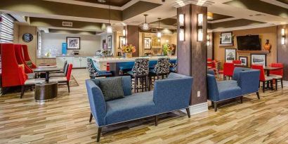 colorful lobby and coworking space at Hampton Inn San Francisco Airport.