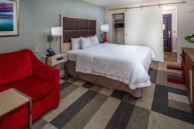 colorful king suite with natural light at Hampton Inn San Francisco Airport.