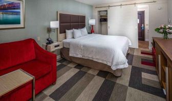 Colorful king suite with natural light at Hampton Inn San Francisco Airport.