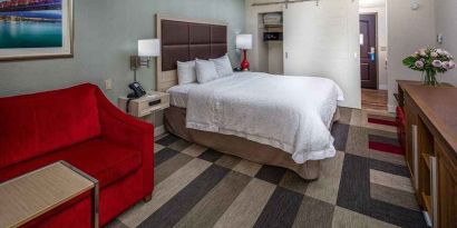 colorful king suite with natural light at Hampton Inn San Francisco Airport.