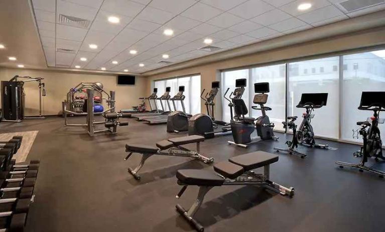 well-equipped fitness center with natural light at Hampton Inn & Suites Las Vegas Convention Center.