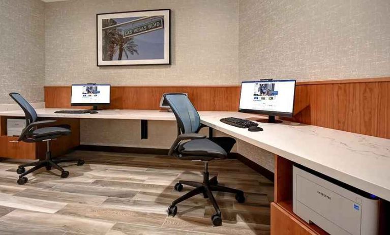 a dedicated business center with work desks, computers, internet, and printers at Hampton Inn & Suites Las Vegas Convention Center.