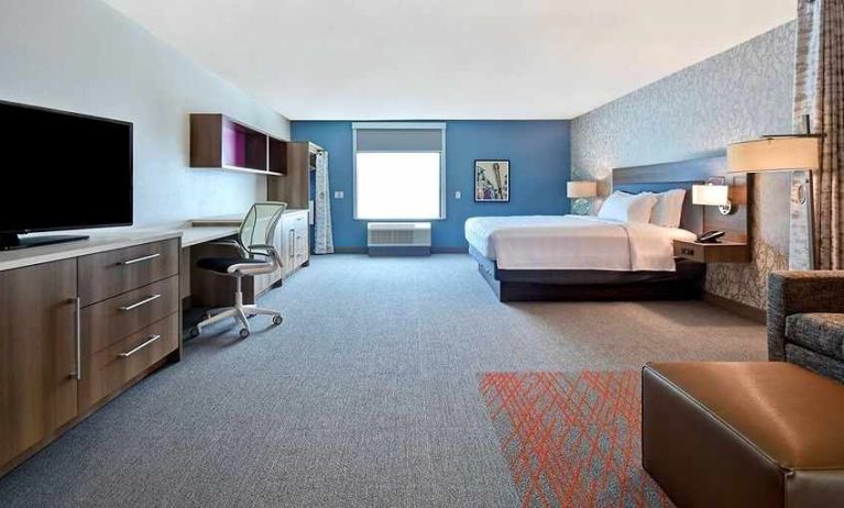 luxurious king suite with work and lounge area at Home2 Suites by Hilton Las Vegas Convention Center.