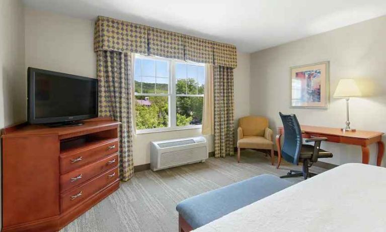 Working station with desk and window in a king bedroom at the Hampton Inn & Suites North Conway.