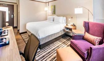 Desk, sofa and king size bed in a king bedroom at the Hilton Garden Inn Minneapolis Airport Mall of America.