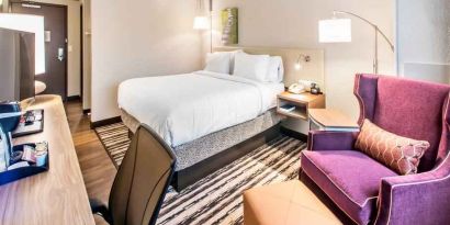 Desk, sofa and king size bed in a king bedroom at the Hilton Garden Inn Minneapolis Airport Mall of America.