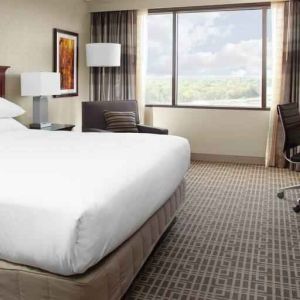 King size bed and desk in a king guestroom at the DoubleTree by Hilton Kansas City - Overland Park.