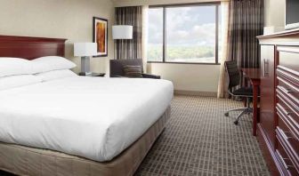 King size bed and desk in a king guestroom at the DoubleTree by Hilton Kansas City - Overland Park.