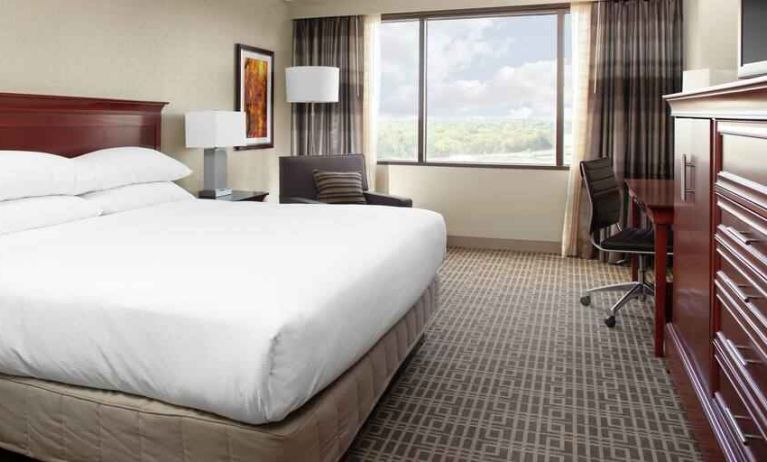 King size bed and desk in a king guestroom at the DoubleTree by Hilton Kansas City - Overland Park.