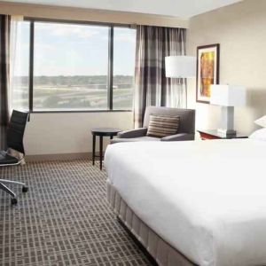 Bright and comfoertable king bedroom with window at the DoubleTree by Hilton Kansas City - Overland Park.