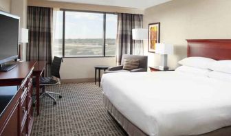 Bright and comfoertable king bedroom with window at the DoubleTree by Hilton Kansas City - Overland Park.