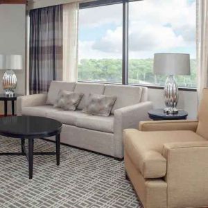 Living area with working station in a hotel suite at the DoubleTree by Hilton Kansas City - Overland Park.