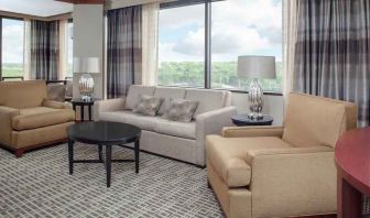 Living area with working station in a hotel suite at the DoubleTree by Hilton Kansas City - Overland Park.