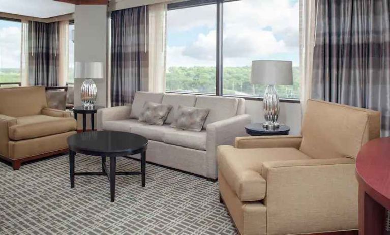 Living area with working station in a hotel suite at the DoubleTree by Hilton Kansas City - Overland Park.