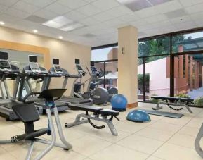 Bright fitness center with treadmills at the Hilton San Antonio-Airport.