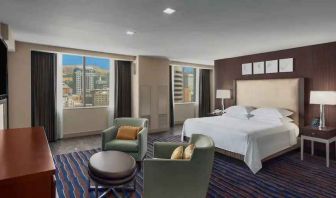 Spacious bedroom with king size bed in a hotel suite at the Hilton Salt Lake City Center.