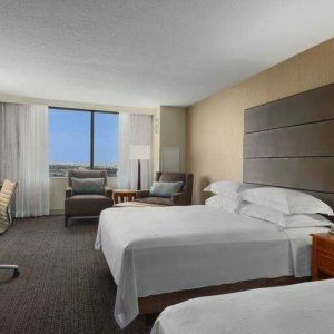 Bright double queen room with window and desk at the Hilton Salt Lake City Center.