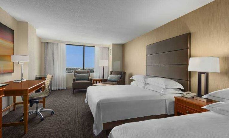 Bright double queen room with window and desk at the Hilton Salt Lake City Center.