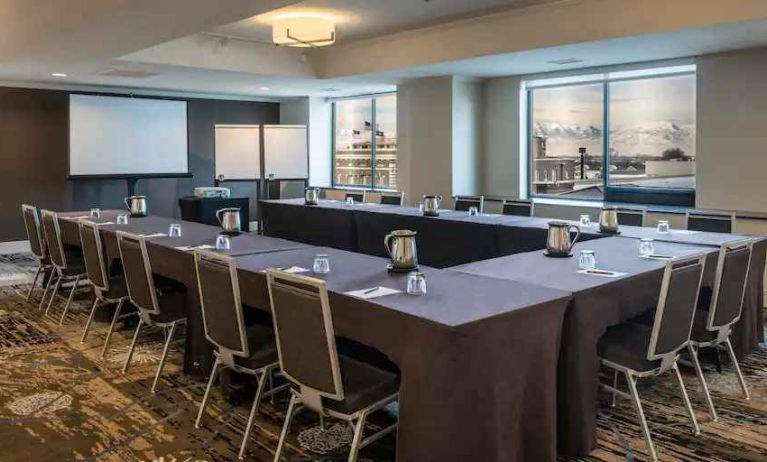 Meeting room with screen and windows at the Hilton Salt Lake City Center.