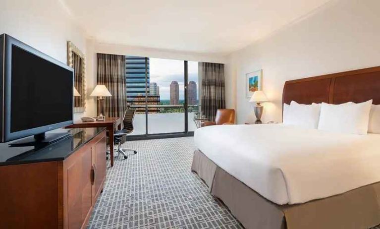 luxurious king suite with work area and city views at Hilton Houston Post Oak by the Galleria.