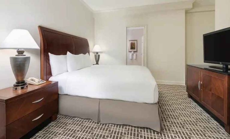 comfortable king bedroom with work desk and TV at Hilton Houston Post Oak by the Galleria.