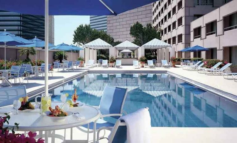 gorgeous outdoor pool with sun beds and seating area at Hilton Houston Post Oak by the Galleria.