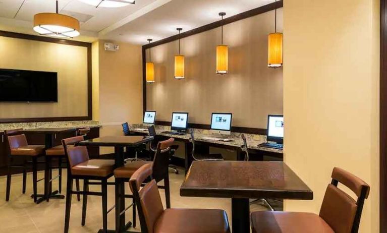 spacious business center with computers, tables, and workspaces for digital nomad work at Hilton Houston Post Oak by the Galleria.