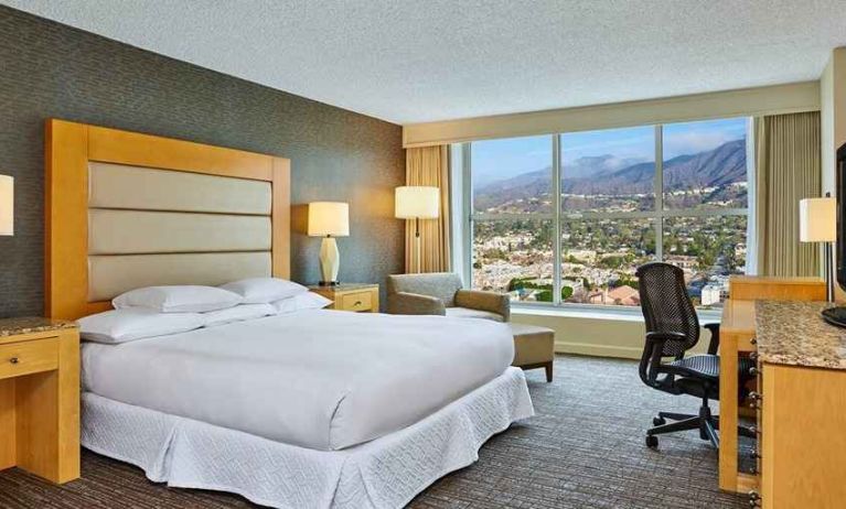 spacious king suite with natural light and work desk at Hilton Los Angeles North/Glendale & Executive Meeting Ctr.