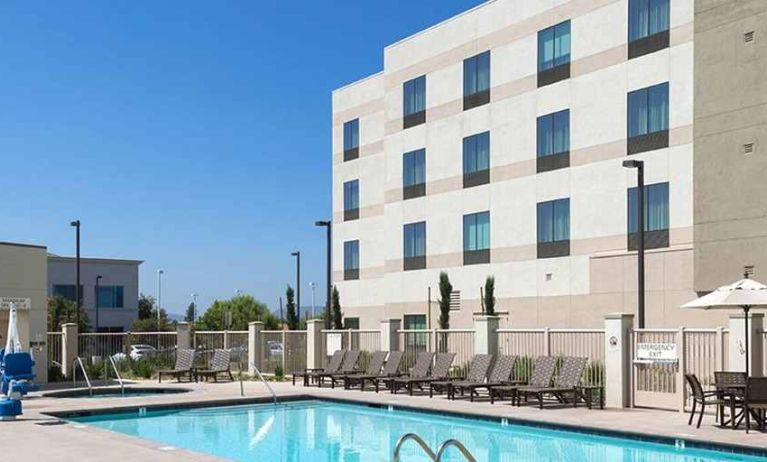 beautiful outdoor pool with seating area and sun beds at Hampton Inn & Suites Murrieta Temecula.