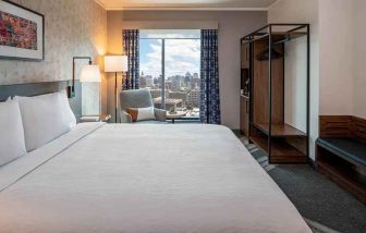 Spacious king suite with business desk and city views at Hilton Garden Inn Austin University.