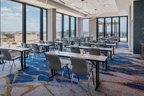 professional conference room with a lot of natural light and city views at Hilton Garden Inn Austin University.