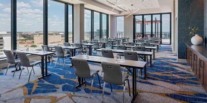 Professional conference room with a lot of natural light and city views at Hilton Garden Inn Austin University.