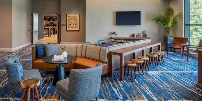 A coworking space with lots of natural light at Hilton Garden Inn Austin University.