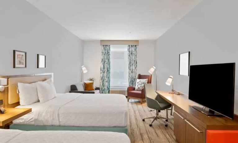 Double queen bedroom with TV screen and desk at the Hilton Garden Inn Houston Medical Center, TX.