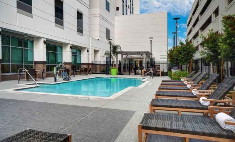 Outdoor pool area with lounges at the Hilton Garden Inn Houston Medical Center, TX.