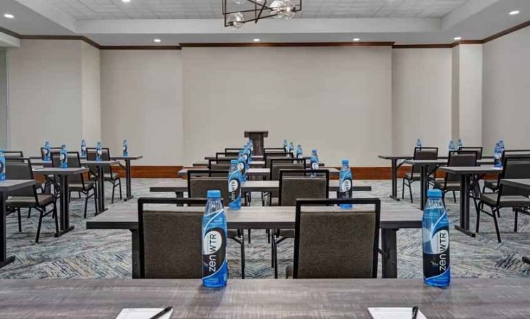 Large meeting room with tables and chairs at the Hilton Garden Inn Houston Medical Center, TX.