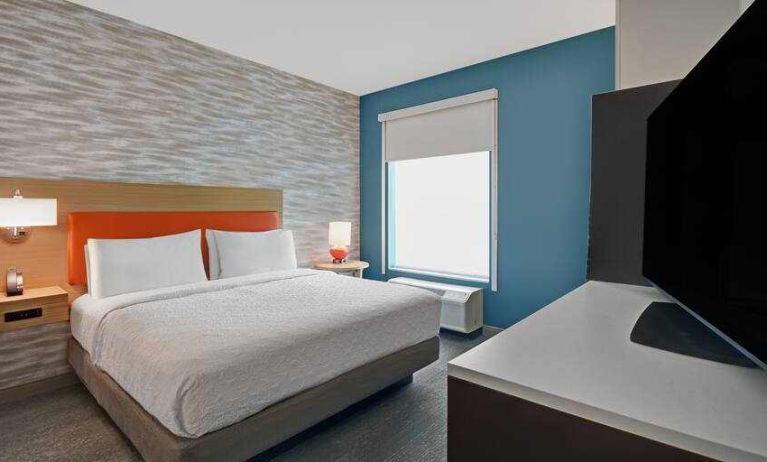 Comfortable bedroom with window at the Home2 Suites by Hilton Houston Medical Center.